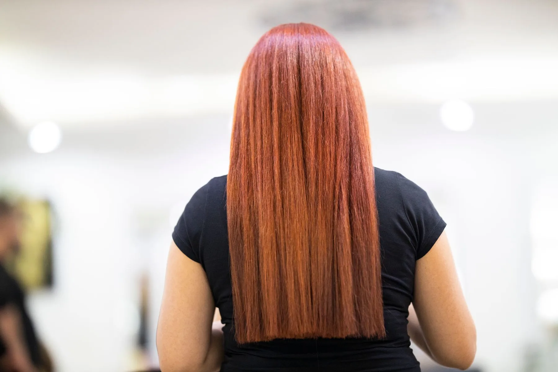 Straight, shiny red hair seen from the back